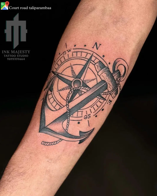 Medium Black and Grey Anchor and Compass Tattoo on Men Arm by @tattoo_ink_majesty_taliparamba