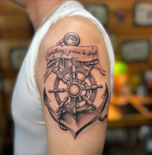 Medium Black and Grey Anchor and Ship Wheel Tattoo on Men Arm by @strokertattoo