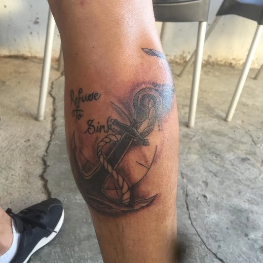 Medium Black and Grey Anchor with Banner Tattoo on Men Leg by @ink.magination_tattoos