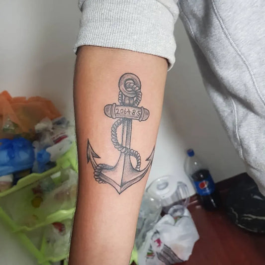 Medium Black and Grey Anchor with Rope and Date Tattoo on Men Arm by @tattooist_khambu