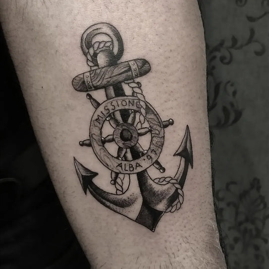 Medium Black and Grey Anchor with Wheel and Rope Tattoo on Men Arm by @satirozerotattoo