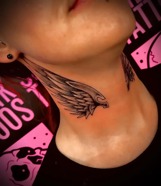 Medium Black and Grey Angel Wings Tattoo on Women Neck by @spiltinktattoos