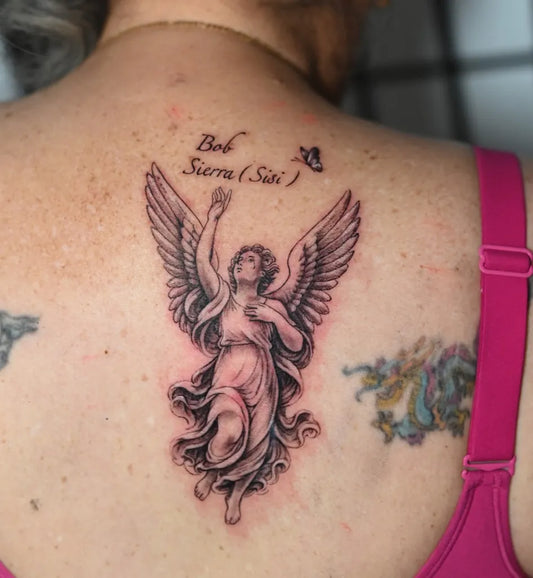 Medium Black and Grey Angel with Wings and Text on Women Back Tattoo by @mohanstattooinn