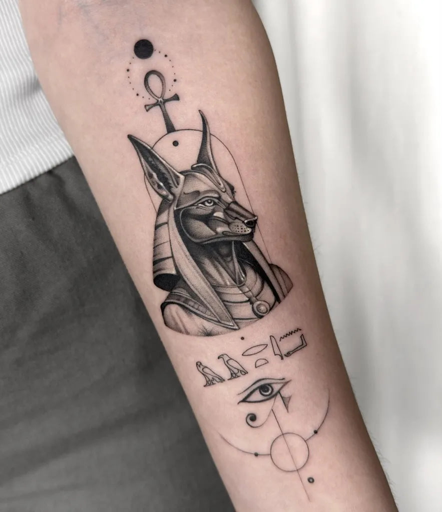 Medium Black and Grey Anubis Eye of Horus Tattoo on Women Arm by @acra.tat