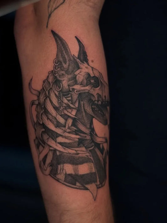 Medium Black and Grey Anubis Skull Tattoo on Men Arm by @flip.ink