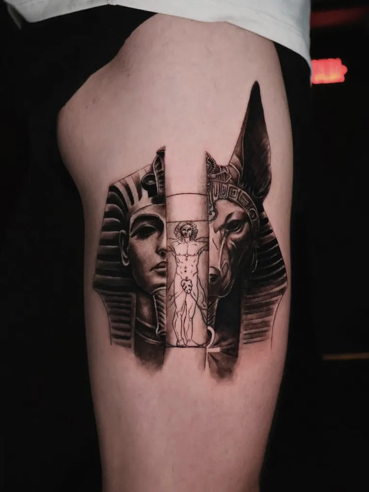 Medium Black and Grey Anubis and Pharaoh Tattoo on Men Thigh by @tintaoculta_tattoo