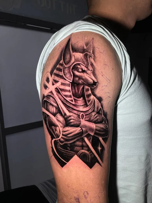 Medium Black and Grey Anubis with Ankh and Stars Tattoo on Men Shoulder by @bors_ink