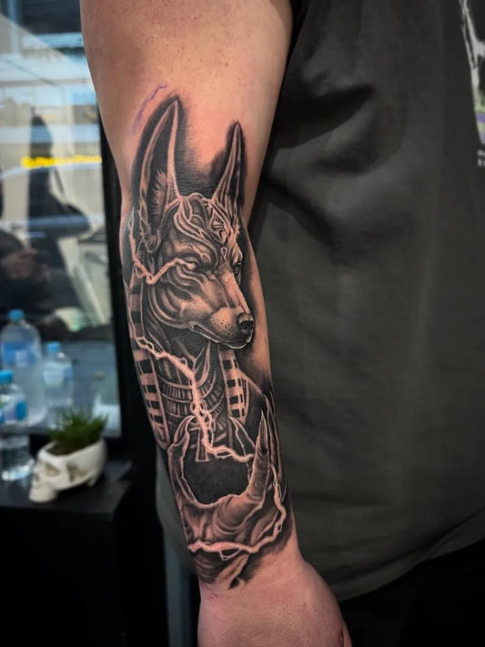 Medium Black and Grey Anubis with Lightning Tattoo on Men Arm by @nthtattoos