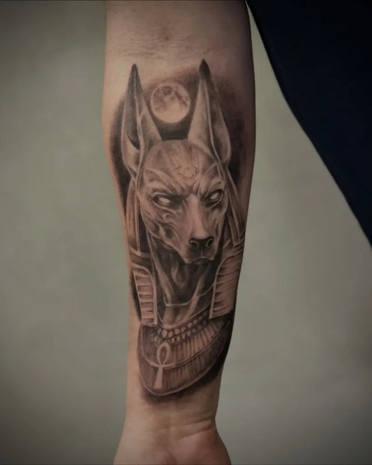 Medium Black and Grey Anubis with Moon Tattoo on Men Arm by @kingsofinkkrakow