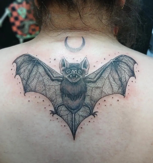 Medium Black and Grey Bat Crescent Moon Tattoo on Women Back by @trilogytattoos