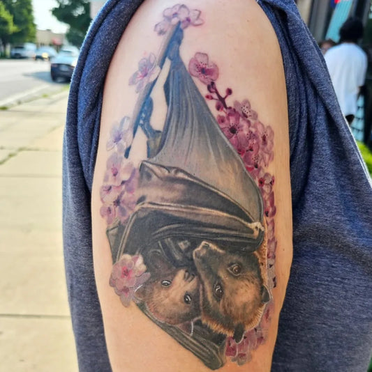 Medium Black and Grey Bat and Cherry Blossoms Tattoo on Women Arm by @tattoosbynadia