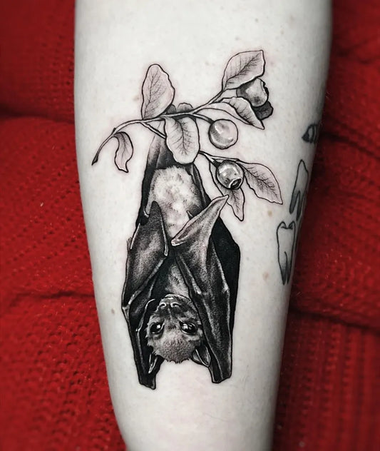 Medium Black and Grey Bat and Leaves Tattoo on Women Arm by @yello__alien