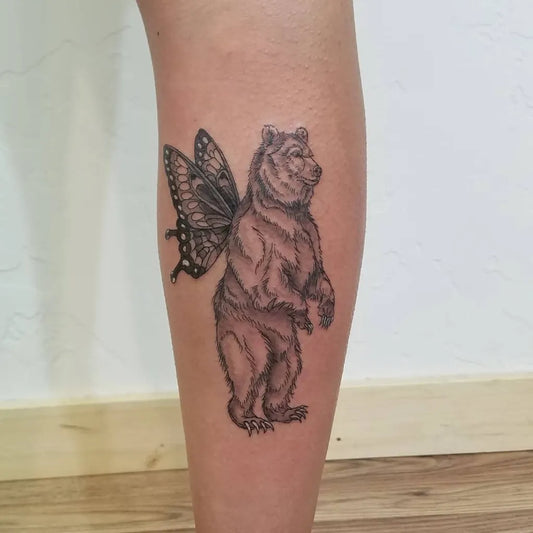Medium Black and Grey Bear with Butterfly Wings Tattoo on Women Calf by @feral_mtnwoman