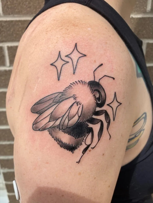 Medium Black and Grey Bee with Stars on Women Shoulder Tattoo by @juniperonfire