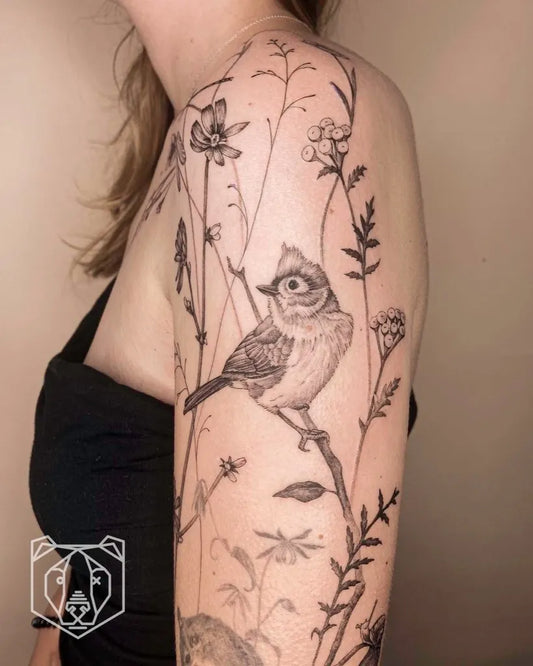 Medium Black and Grey Bird and Flowers Tattoo on Women Shoulder by @blackbear.ink