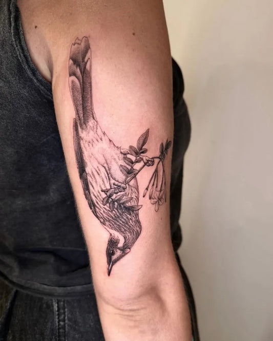Medium Black and Grey Bird with Flowers and Leaves Tattoo on Women Arm by @wrenling
