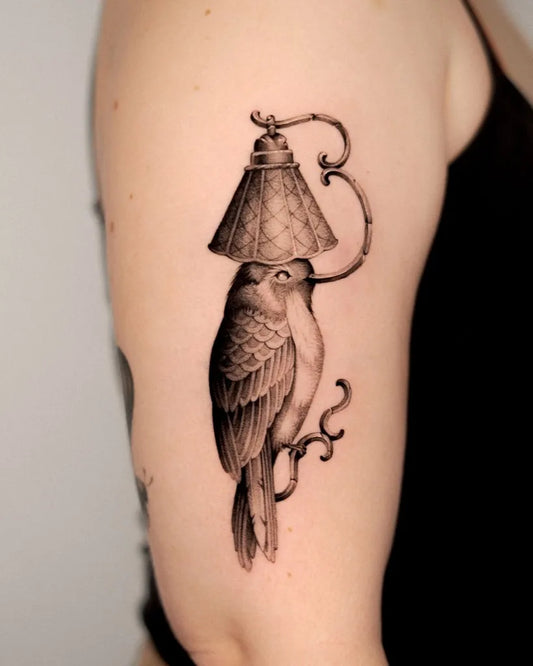 Medium Black and Grey Bird with Lamp Tattoo on Women Arm by @prettypat.tats