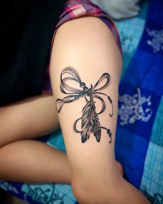 Medium Black and Grey Bow and Feather Tattoo on Women Thigh by @theyashdass
