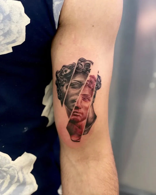 Medium Black and Grey Broken David Bust Tattoo on Men Bicep by @hawktattooofficial