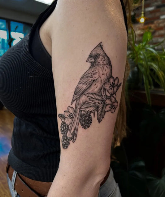 Medium Black and Grey Cardinal with Flowers and Berries Tattoo on Women Arm by @inked.alchemy