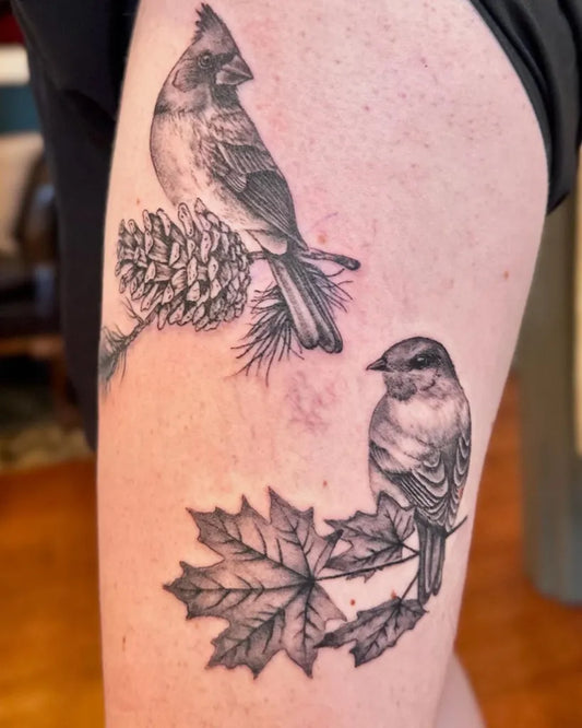 Medium Black and Grey Cardinals and Pine Cone Tattoo on Women Thigh by @tattoosbyjamma
