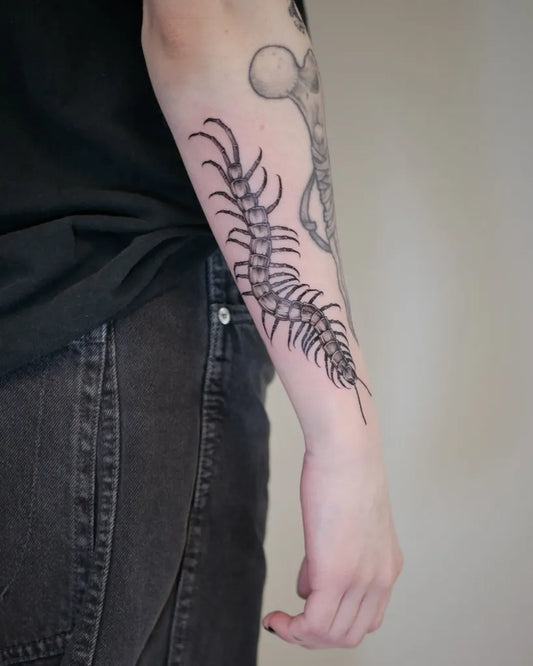 Medium Black and Grey Centipede Tattoo on Women Arm by @artelius_tattoo