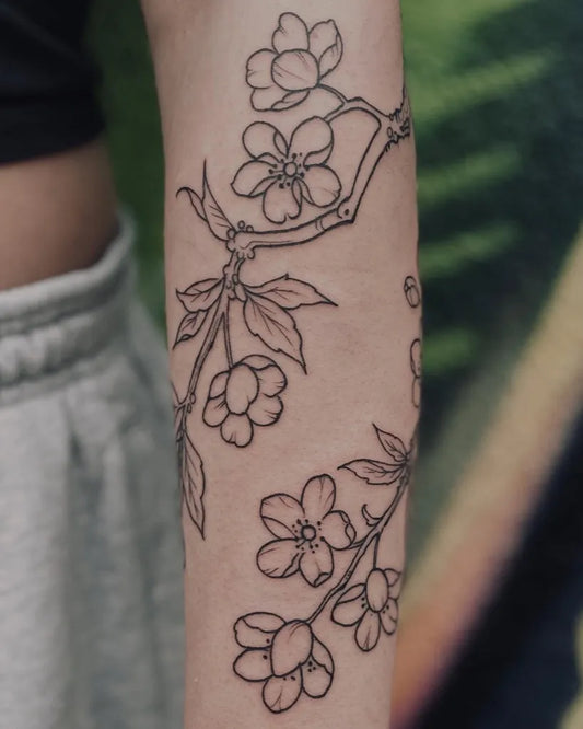 Medium Black and Grey Cherry Blossom Branch on Women Arm Tattoo by @rivkah.inkweaver