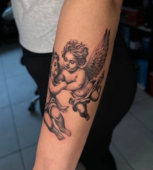 Medium Black and Grey Cherub Angels Tattoo on Women Arm by @av_tatts