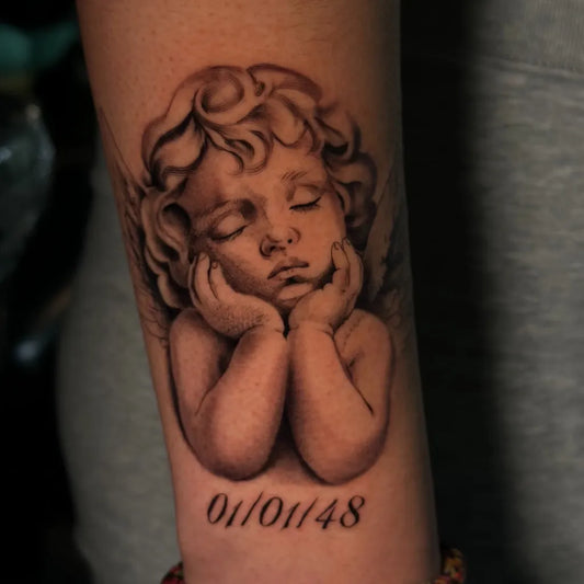 Medium Black and Grey Cherub Tattoo on Women Arm by @lilyeileentattoos