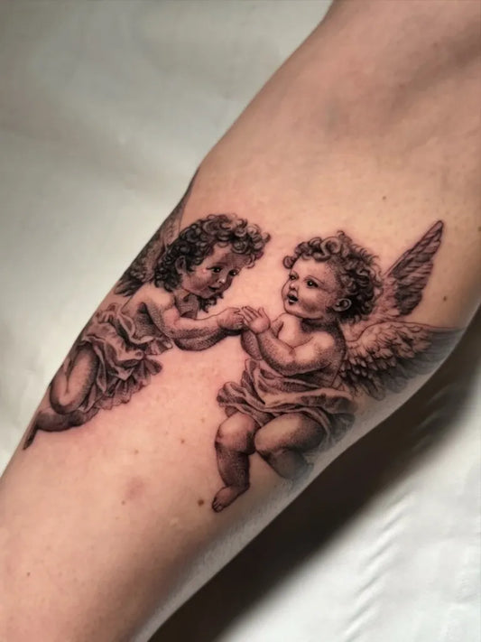 Medium Black and Grey Cherubs Tattoo on Women Arm by @thebrzy.tattoo
