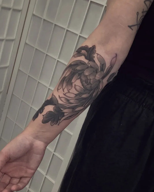 Medium Black and Grey Chrysanthemum and Leaves Tattoo on Women Arm by @brookesteele_tattoos