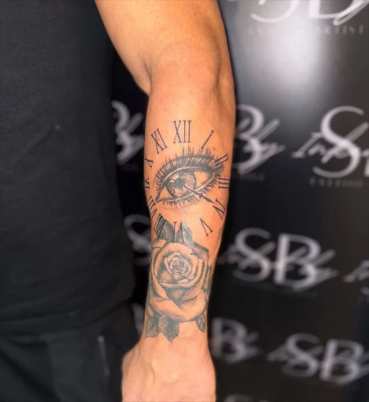 Medium Black and Grey Clock Eye Rose Tattoo on Men Arm by @inked_by_sb