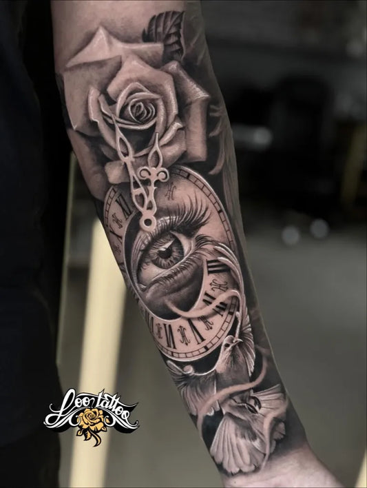 Medium Black and Grey Clock Rose Eye Tattoo on Men Arm by @lootattoo