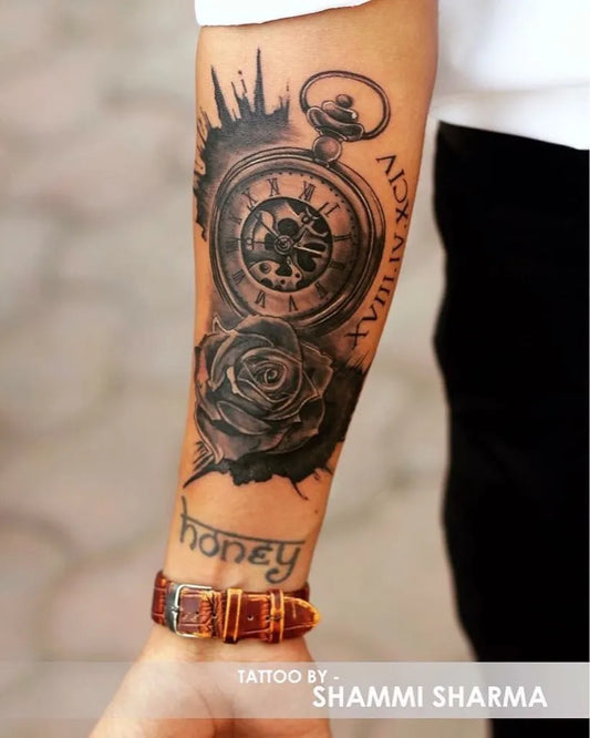 Medium Black and Grey Clock Rose Honey Tattoo on Men Arm by @immy.artwork