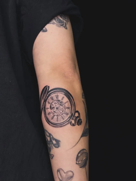 Medium Black and Grey Clock and Flowers Tattoo on Women Arm by @ryan.zerota