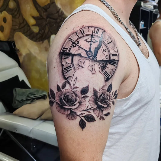 Medium Black and Grey Clock with Couple Silhouettes and Roses Tattoo on Men Shoulder by @martintattookm