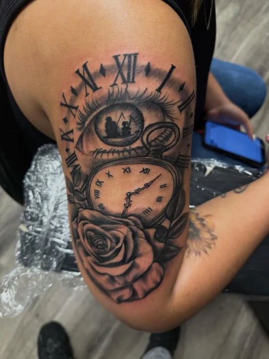 Medium Black and Grey Clock with Eye and Rose Tattoo on Women Arm by @ecko_tatts