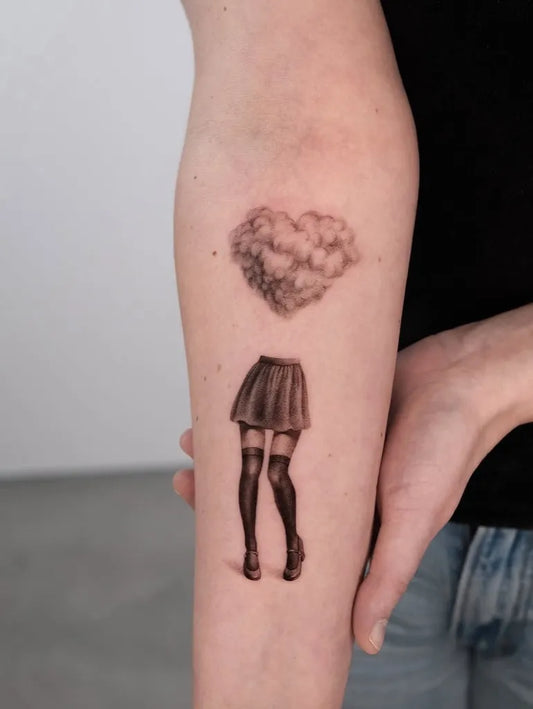 Medium Black and Grey Cloud Heart Skirt Tattoo on Women Arm by @inker_land