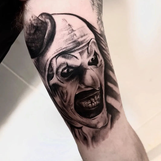 Medium Black and Grey Clown Portrait Horror Tattoo on Men Arm by @toast_tattoos