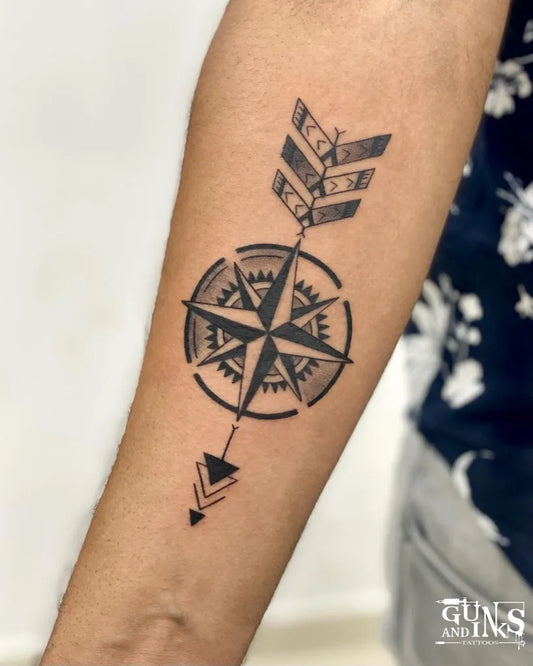 Medium Black and Grey Compass Arrow Tattoo on Women Forearm by @gunsandinkstattoos