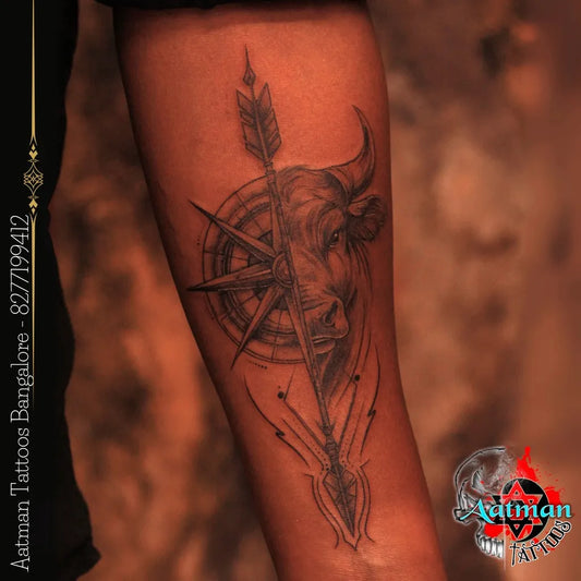 Medium Black and Grey Compass Bull Arrow on Men Arm Tattoo by @aatman_tattoos_bangalore