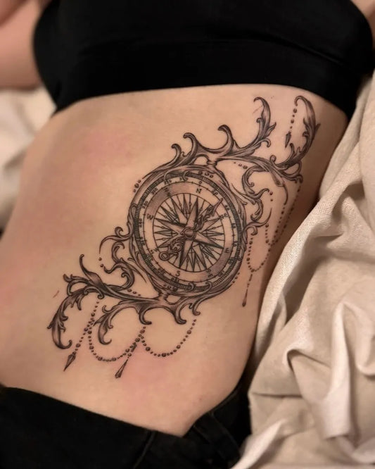 Medium Black and Grey Compass with Floral Chains on Women Side Tattoo by @hammersmith_tattoo_london