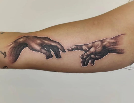 Medium Black and Grey Creation of Adam Hands Tattoo on Women Bicep by @rochertat