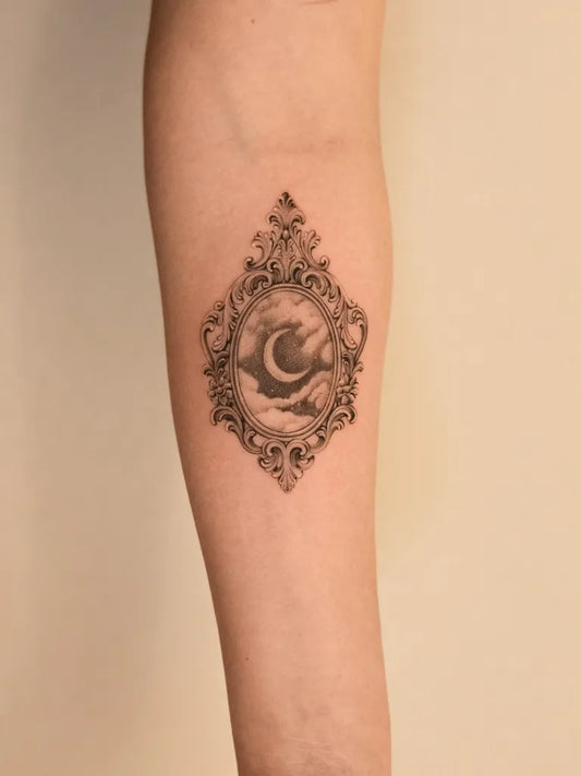 Medium Black and Grey Crescent Moon Frame Tattoo on Women Arm by @jodiehedley.tattoos
