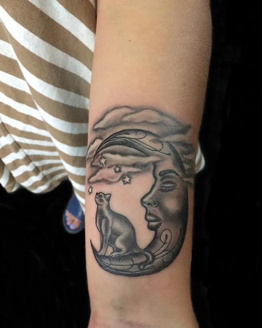 Medium Black and Grey Crescent Moon with Cat and Face Tattoo on Women Arm by @aji_yujiro_ink