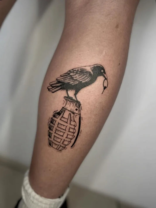 Medium Black and Grey Crow on Grenade Tattoo on Men Leg by @inked_by_alice