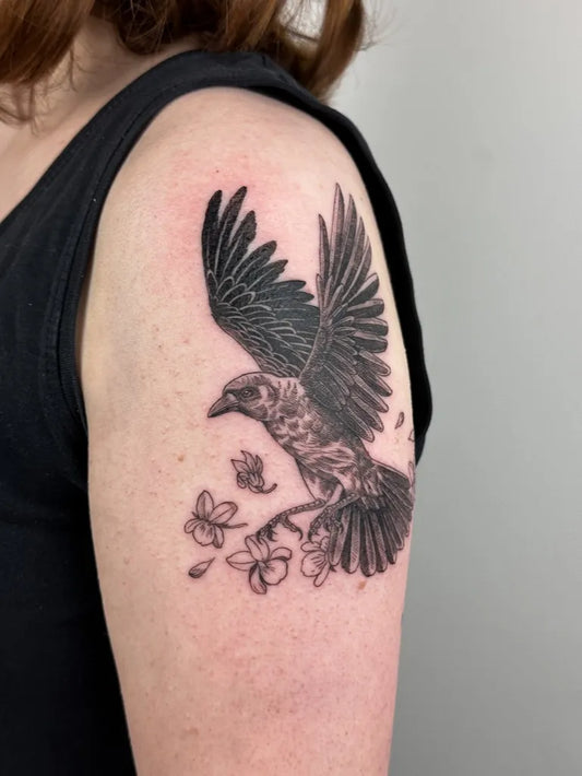 Medium Black and Grey Crow with Flowers Tattoo on Women Shoulder by @bermigram