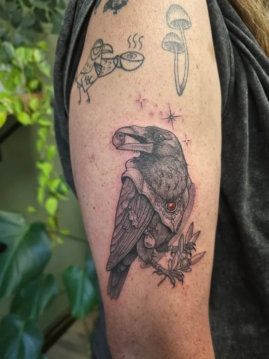 Medium Black and Grey Crow with Mushroom Tattoo on Women Arm by @jacgtattoos