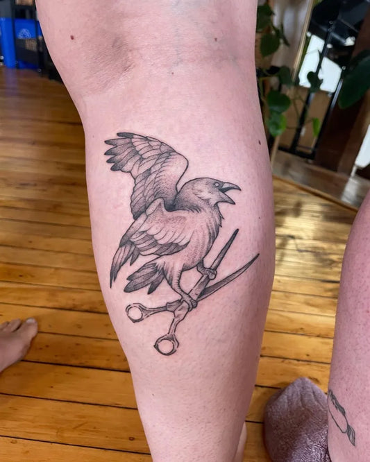 Medium Black and Grey Crow with Scissors Tattoo on Women Thigh by @bekmurrell