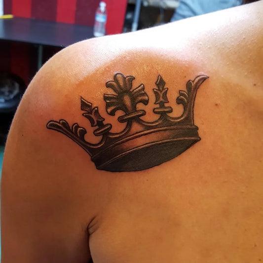 Medium Black and Grey Crown Tattoo on Men Shoulder by @davemantattoos